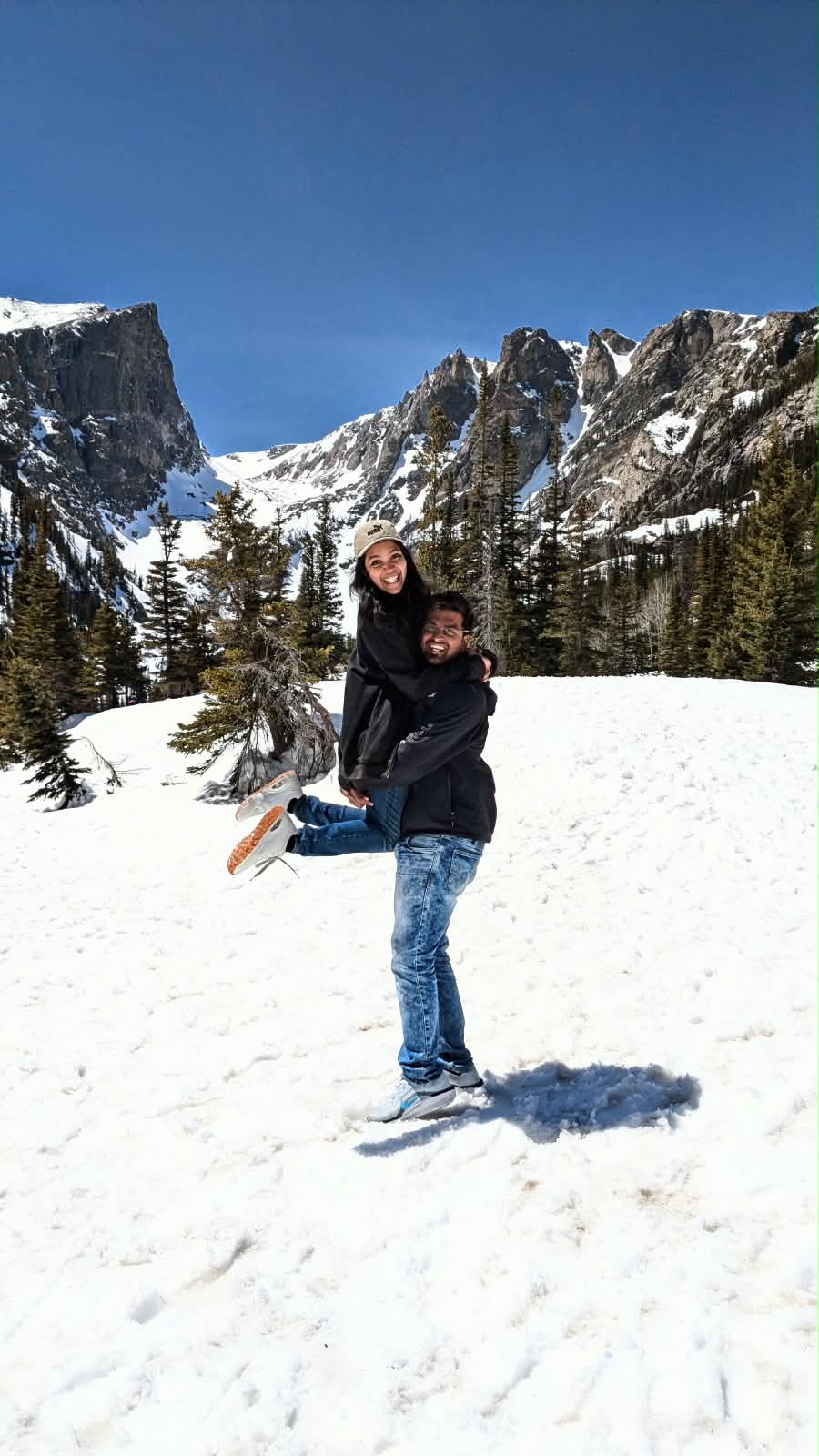 Deepthi and Adith Kiran in the snowy Rocky Mountains near Denver