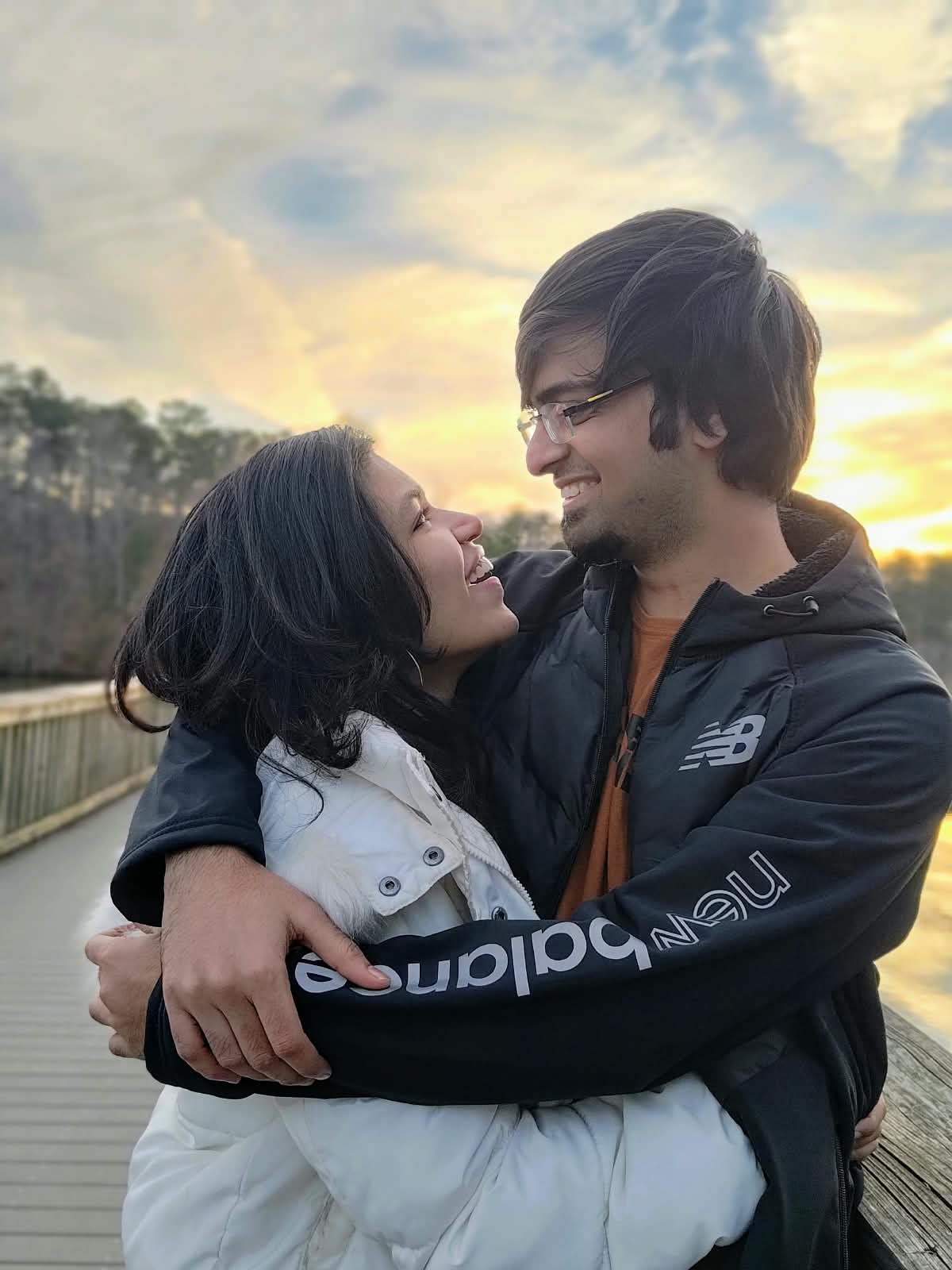 Deepthi and Adith Kiran by a lake at sunset in Raleigh